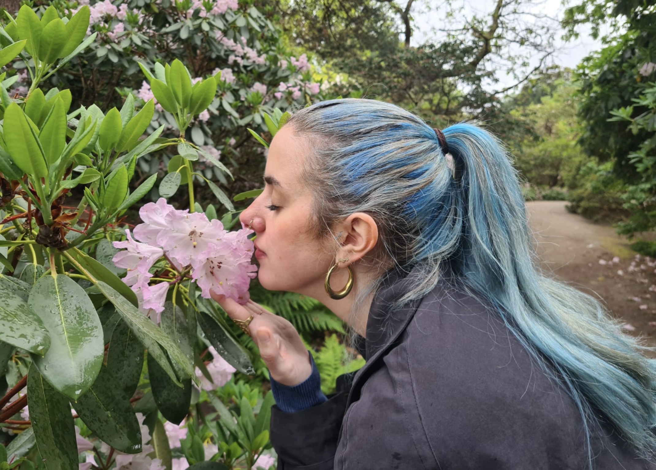 Amy smelling flowers in nature
